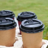 8oz reclosable black lid in use